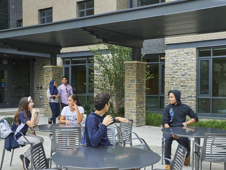 Students sitting outside of Penn State Abington Lions Gate on Patio near Philadelphia